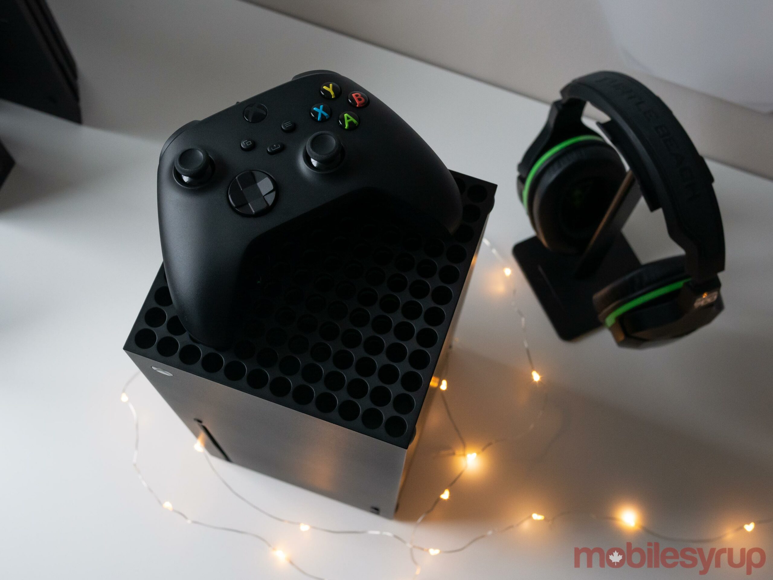Xbox Series X with gamepad on top of it